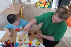 Chlapec s paní vychovatelkou výtvarně tvoří.