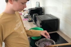 Chlapec dává šeřík do hrnce.