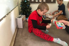 Chlapec rozbaluje dárek.