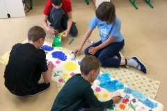 Třída pracuje na společném výtvarném dílu.